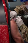 Master Sgt. John McDowell, an aerospace medic with the 157th Medical Group, administers a COVID-19 vaccination in Concord on Jan. 6, 2021.