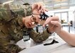 A women in military uniform adjusts a medical device