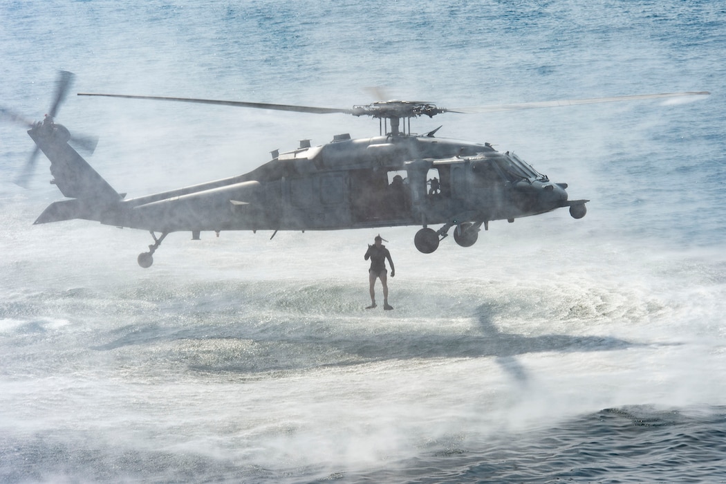 An MH-60S Sea Hawk helicopter, attached to the "Dragon Slayers" of Helicopter Sea Combat Squadron (HSC) 11, embarked to the aircraft carrier USS Harry S. Truman (CVN 75) deploys a rescue swimmer during a search and rescue exercise in the Arabian Sea Jan. 26, 2020