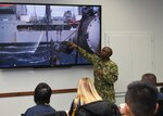 Lt. Nana Bonsu discusses how the Navy resupplies ships at sea during an orientation session for 11 Pennsylvania college students selected for the Department of Defense Cybersecurity Scholarship Program.