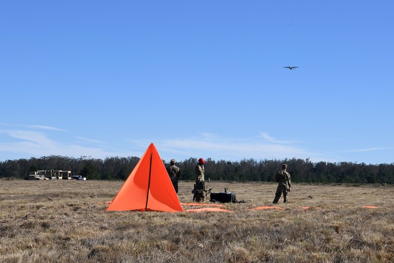 Soldiers assigned to the 346th Theater Aerial Delivery Company, an Army Airborne unit at Joint Forces Training Base Los Alamitos, Calif., speak with aircrew on a Hercules C-130 during a tactical, low-level, static line parachute insertion operation training Jan. 9, 2021, at Vandenberg Air Force Base, Calif.