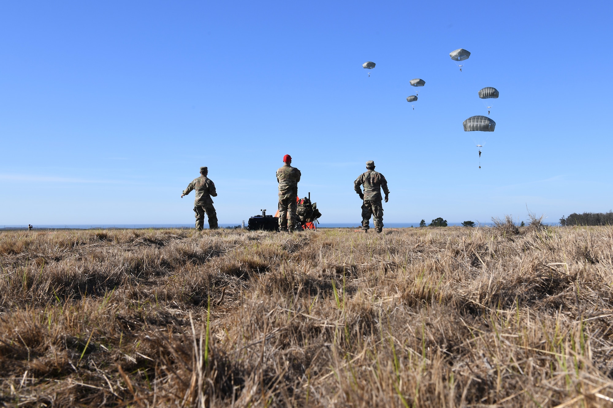 Soldiers assigned to the 346th Theater Aerial Delivery Company, an Army Airborne unit, and Marines, assigned to the 3rd Brigade, 3rd Air Naval Gunfire Liaison Company, Marine Forces Reserve, participate in tactical, low-level, static line parachute insertion operation training Jan. 9, 2021, at Vandenberg Air Force Base, Calif.
