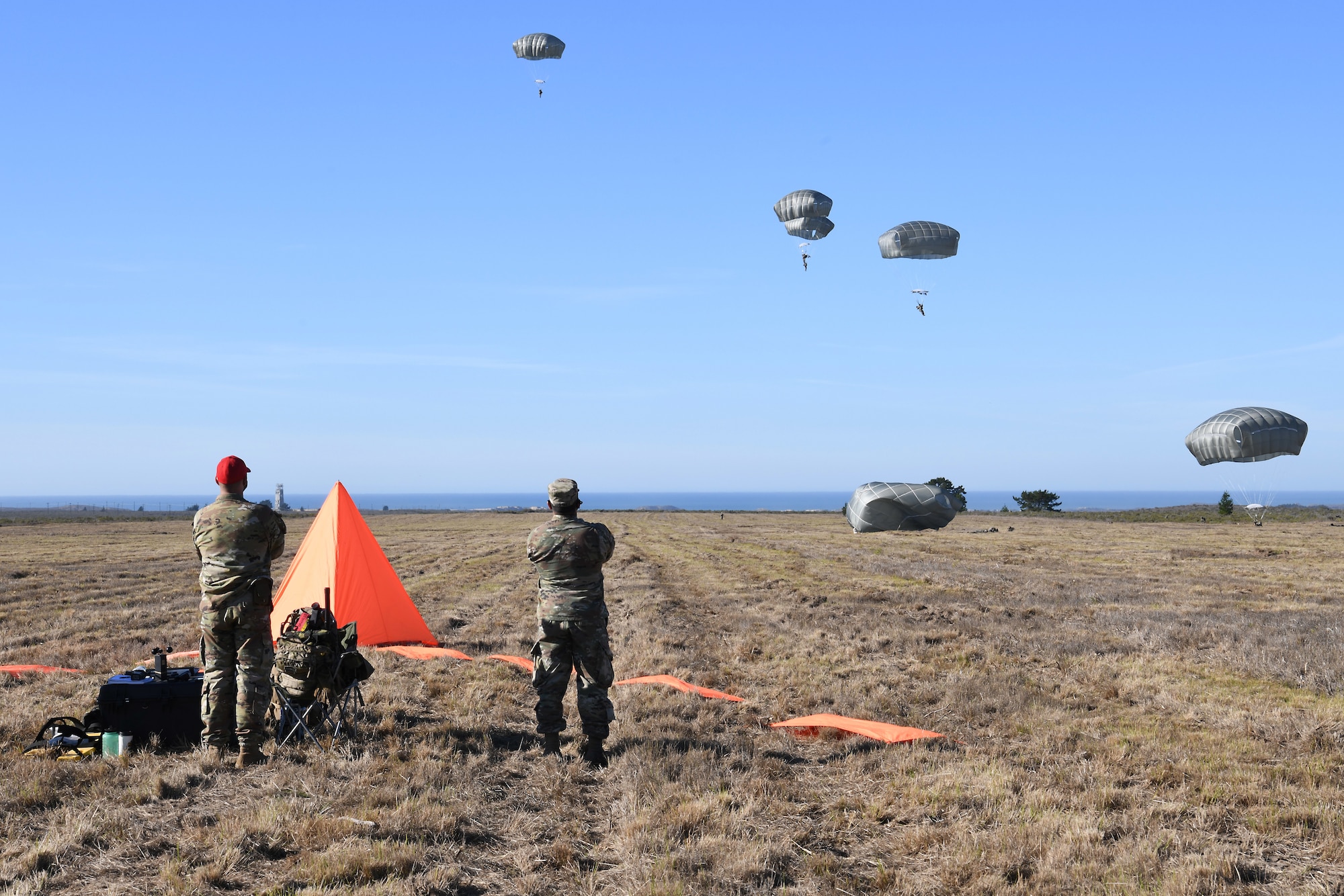 Soldiers assigned to the 346th Theater Aerial Delivery Company, an Army Airborne unit, and Marines, assigned to the 3rd Brigade, 3rd Air Naval Gunfire Liaison Company, Marine Forces Reserve, participate in tactical, low-level, static line parachute insertion operation training Jan. 9, 2021, at Vandenberg Air Force Base, Calif.