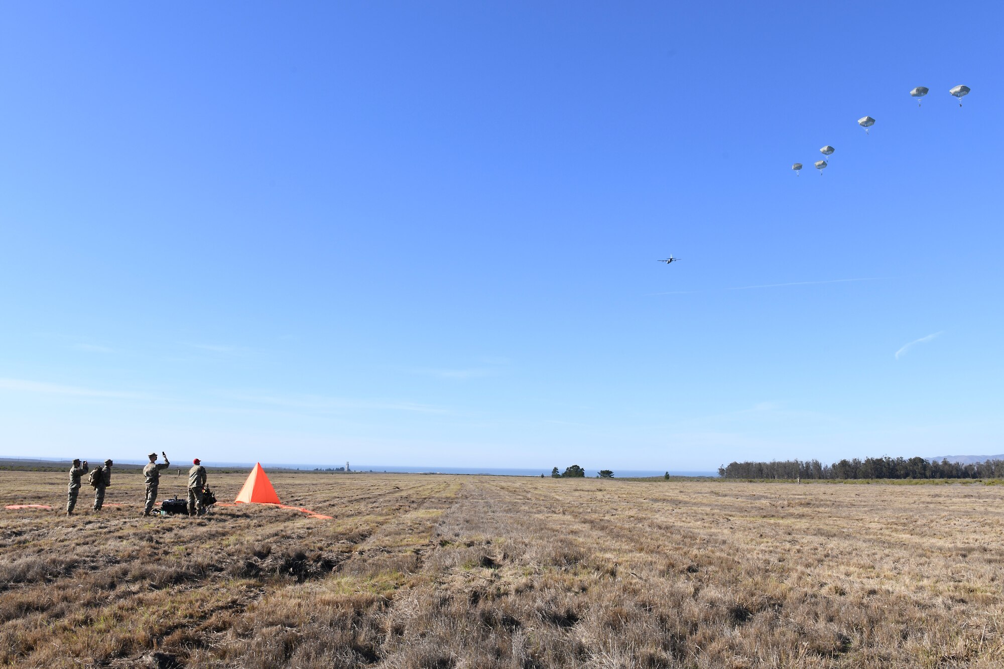 Soldiers assigned to the 346th Theater Aerial Delivery Company, an Army Airborne unit, and Marines, assigned to the 3rd Brigade, 3rd Air Naval Gunfire Liaison Company, Marine Forces Reserve, participate in tactical, low-level, static line parachute insertion operation training Jan. 9, 2021, at Vandenberg Air Force Base, Calif.