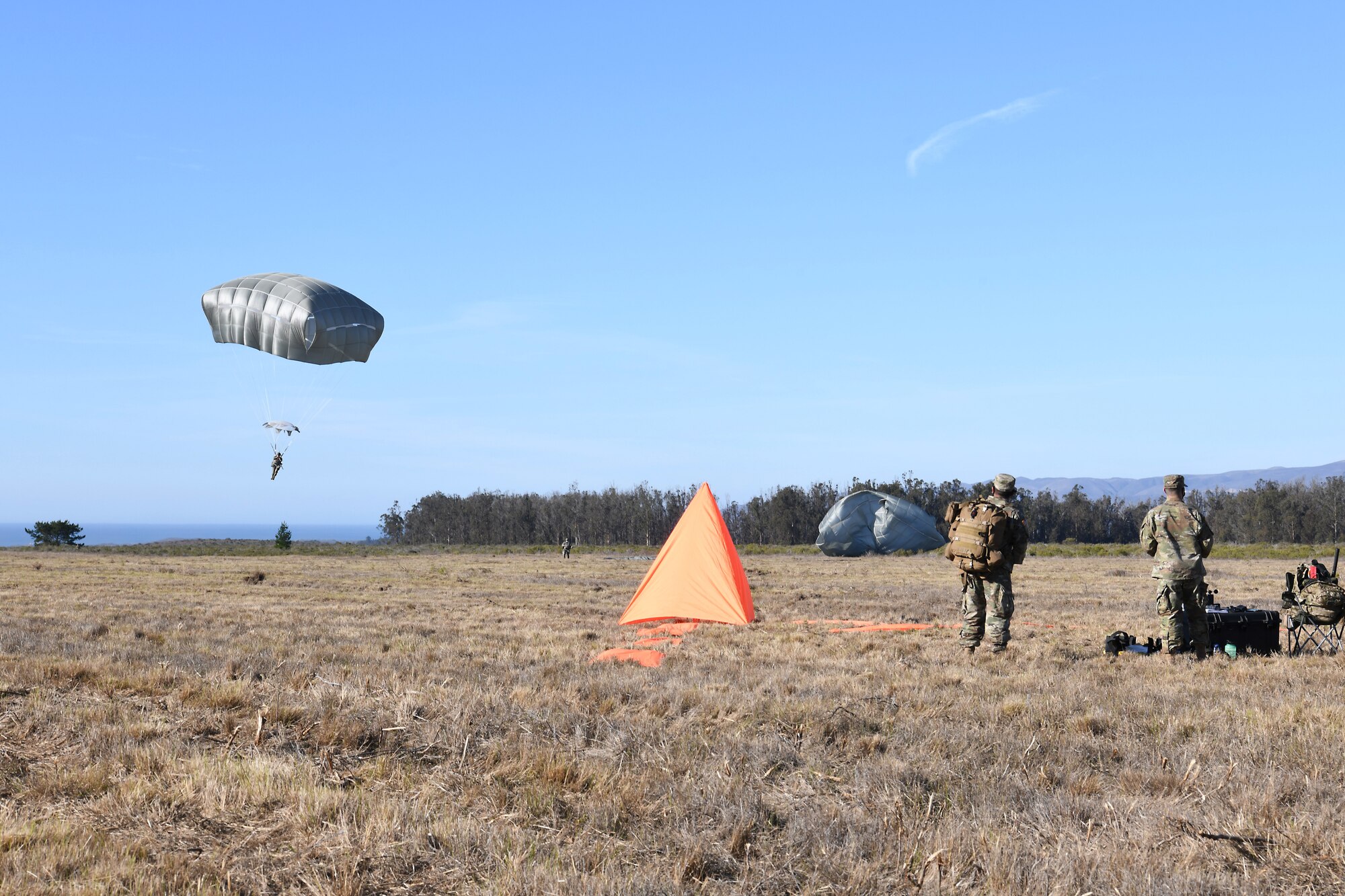 Soldiers assigned to the 346th Theater Aerial Delivery Company, an Army Airborne unit, and Marines, assigned to the 3rd Brigade, 3rd Air Naval Gunfire Liaison Company, Marine Forces Reserve, participate in tactical, low-level, static line parachute insertion operation training Jan. 9, 2021, at Vandenberg Air Force Base, Calif.