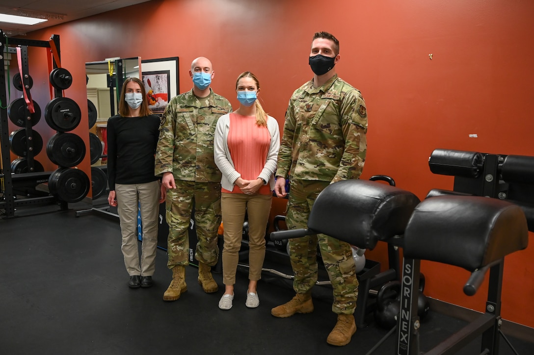(Left to right) Dr. Lonni Scott, Tech. Sgt. David Curley, Dr. Ali Diiorio, and Capt. Brian Diiorio, Physical Therapy Flight Commander, are the physical therapists in the new physical therapy room at 75th Medical Group's clinic. (U.S. Air Force photo by Cynthia Griggs)