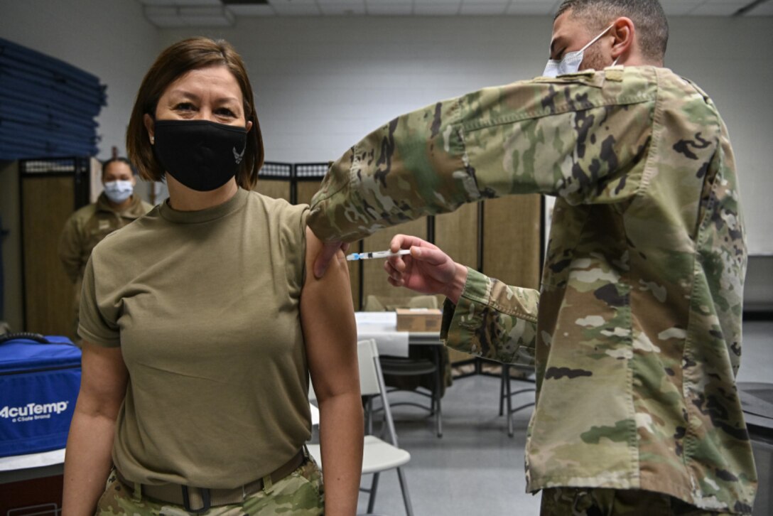 Chief Master Sgt. of the Air Force JoAnne S. Bass receives the COVID-19 vaccine from Senior Airman Aidan Herring, an allergy technician with 316th Medical Squadron, at Joint Base Anacostia-Bolling, Washington, D.C., Jan. 12, 2021. (U.S. Air Force photo by Eric Dietrich)