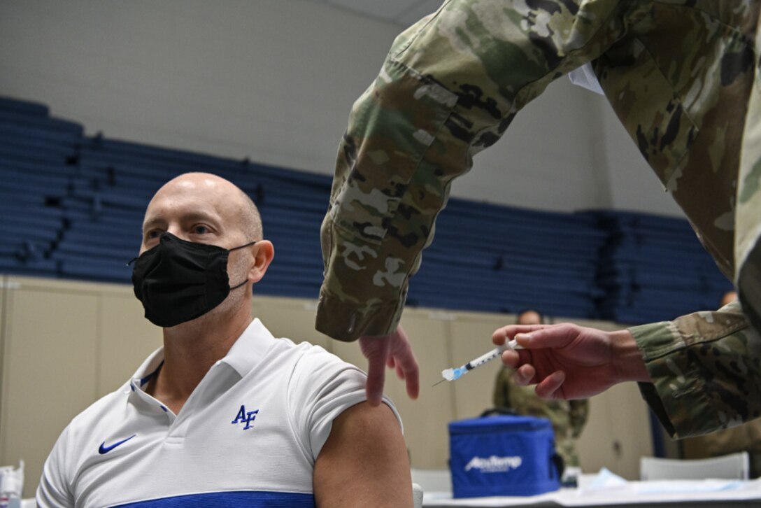 Shon J. Manasco, assistant secretary of the Air Force for manpower and reserve affairs, receives the COVID-19 vaccine from Senior Airman Aidan Herring, an allergy technician with 316th Medical Squadron, at Joint Base Anacostia-Bolling, Washington, D.C., Jan. 12, 2021. (U.S. Air Force photo by Eric Dietrich)
