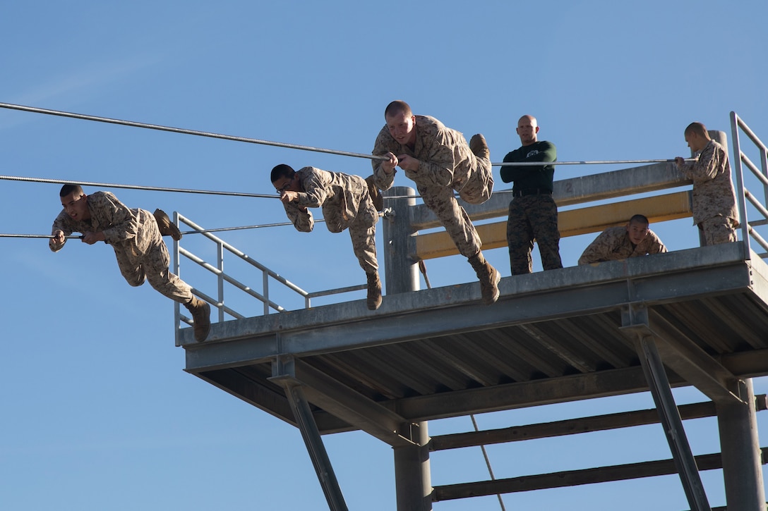 Marines take part in a rope obstacle course.