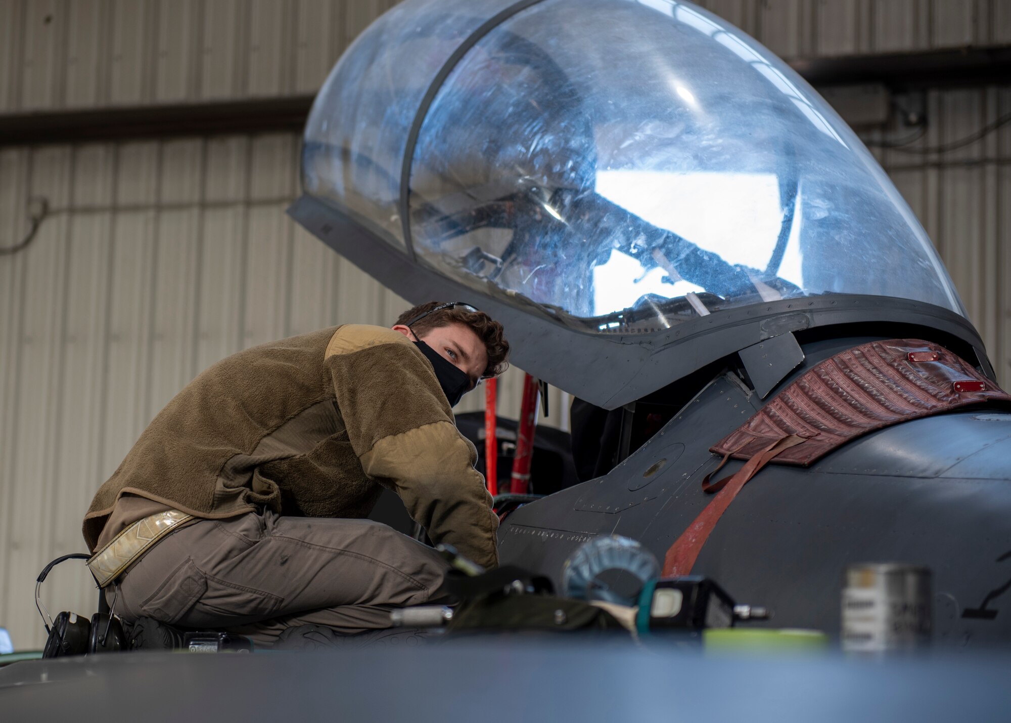 Senior Airman Travis Skaggs, 4th Equipment Maintenance Squadron crew chief, fixes the panel of a F-15E Strike Eagle during a routine inspection at Seymour Johnson Air Force Base, North Carolina, Jan. 7, 2021.