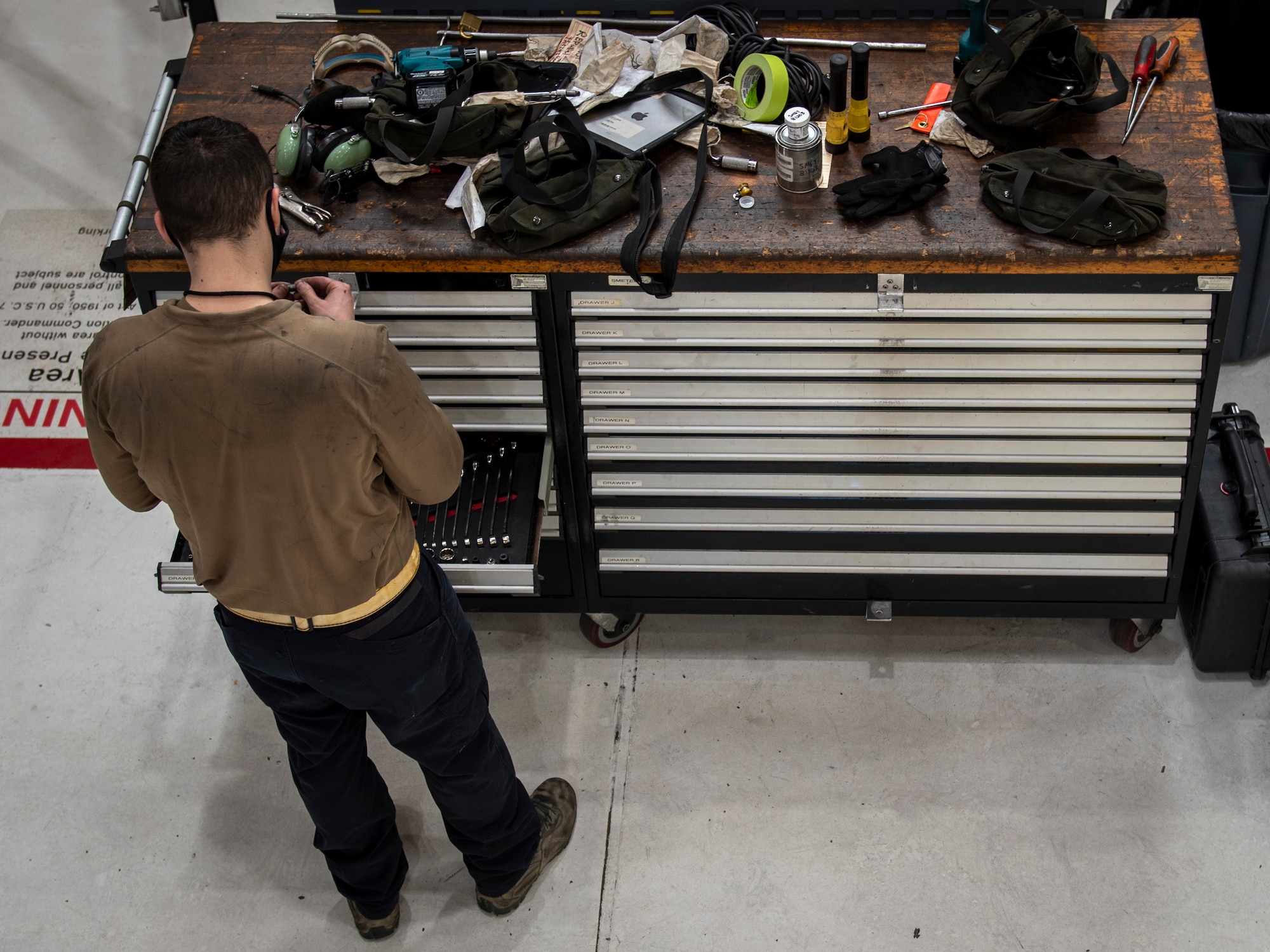 Airman 1st Class Cory Bearden, 4th Equipment Maintenance Squadron crew chief, looks for a tool at Seymour Johnson Air Force Base, North Carolina, Jan. 7, 2021.