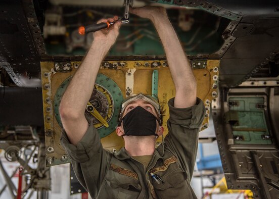 Airman 1st Class Cory Bearden, 4th Equipment Maintenance Squadron crew chief, installs a jet fuel starter on a F-15E Strike Eagle during a routine inspection at Seymour Johnson Air Force Base, North Carolina, Jan. 7, 2021.