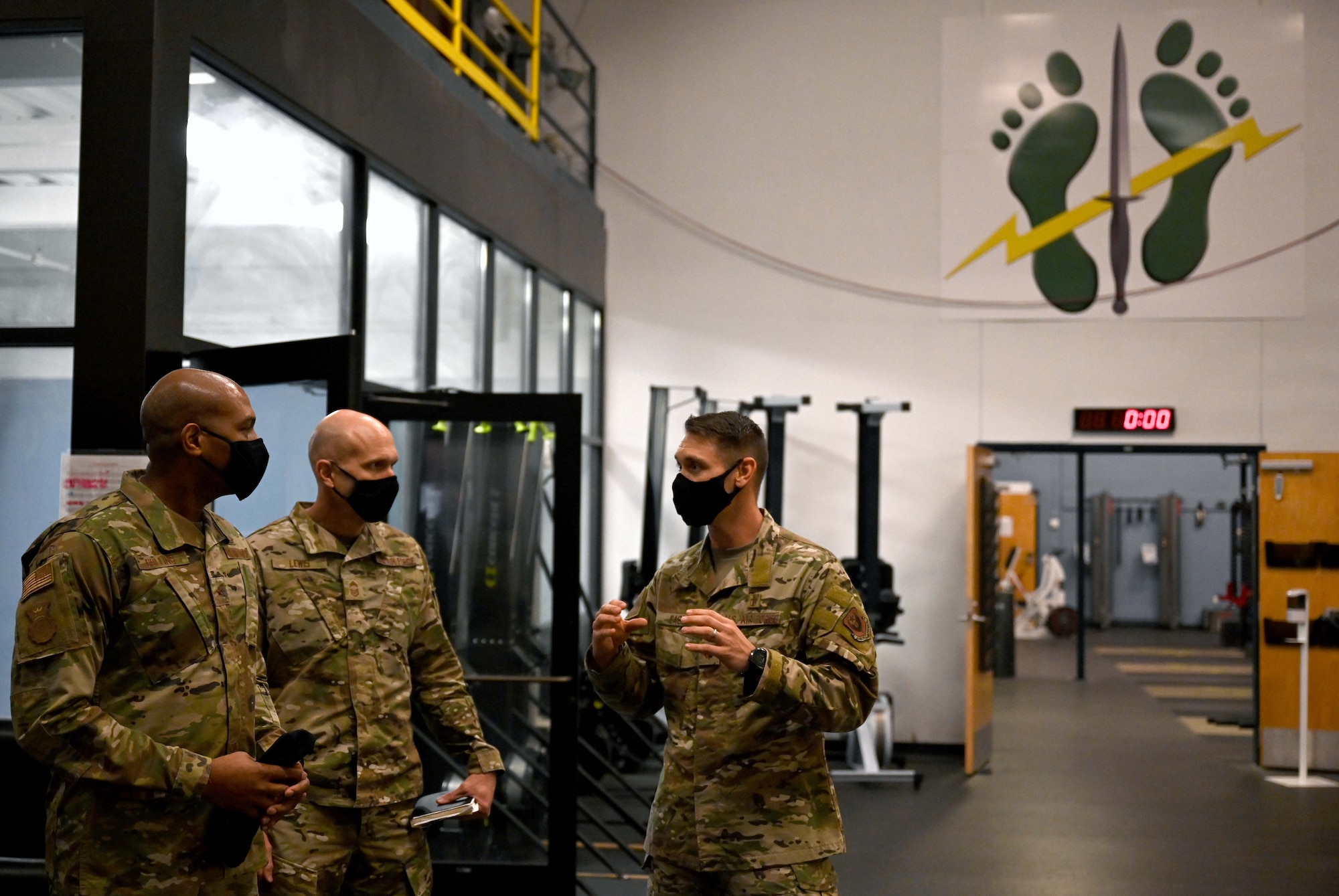 Brigadier General Roy Collins, left, director of Security Forces, deputy chief of staff for Logistics, Engineering and Force Protection, and Chief Master Sgt. Brian Lewis, Security Forces career field manager, receive a brief on the 23rd Special Tactics Squadron’s fitness and rehabilitation facility from Maj. Kyle East, 23rd STS physical therapist, during their visit to Hurlburt Field, Fla., Jan. 11, 2021. During the tour, Collins and Lewis were briefed on the Deployed Aircraft Ground Response Element (DAGRE) training process, took part in a lasershot demonstration, and visited the 23rd STS compound for a mission briefing and a walk around the unit’s multilevel training and fitness facilities. (U.S. Air Force photo by Senior Airman Brandon Esau)