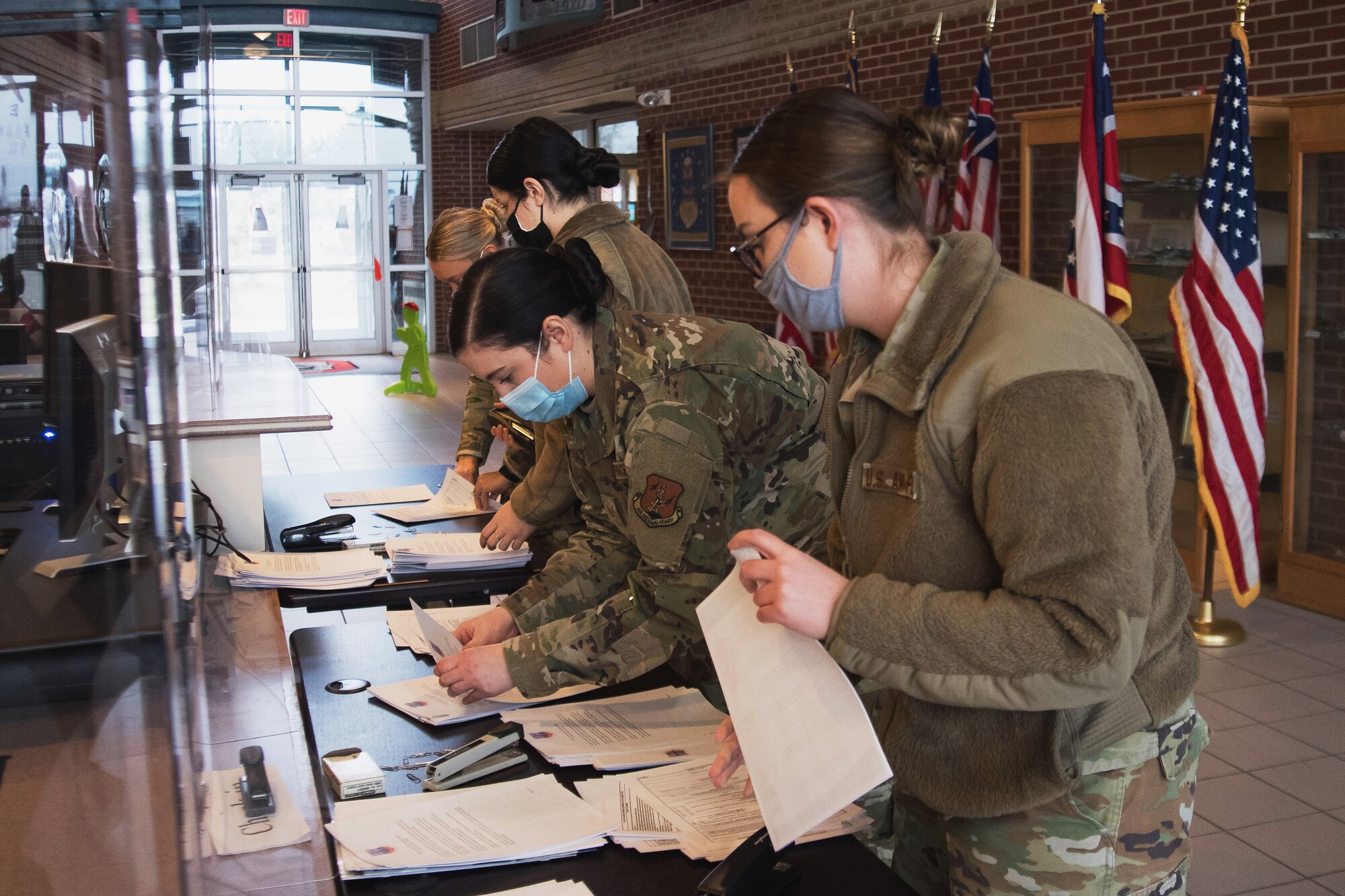 Image of Airmen working on paper work.