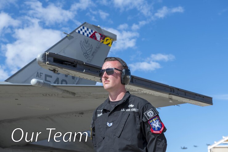 A picture of an Airman next to an F-16 Fighting Falcon.