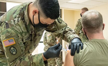 Members of the West Virginia National Guard conduct and participate in a COVID-19 vaccination clinic at Joint Forces Headquarters, Charleston, West Virginia, Jan. 13, 2021. West Virginia maintains one of the highest percentages of vaccine allocation use in the United States and is rapidly expanding capacity to inoculate the population. (U.S. Army National Guard photo by Edwin L Wriston)