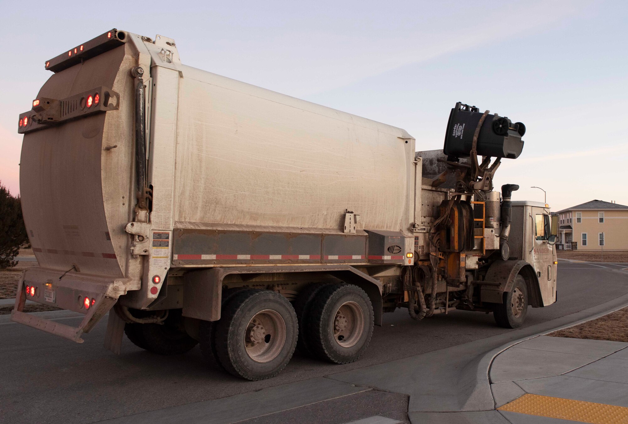 A garbage truck empties a trash can equipped with the Gust device at Ellsworth Air Force Base, S.D., Jan. 7, 2021.