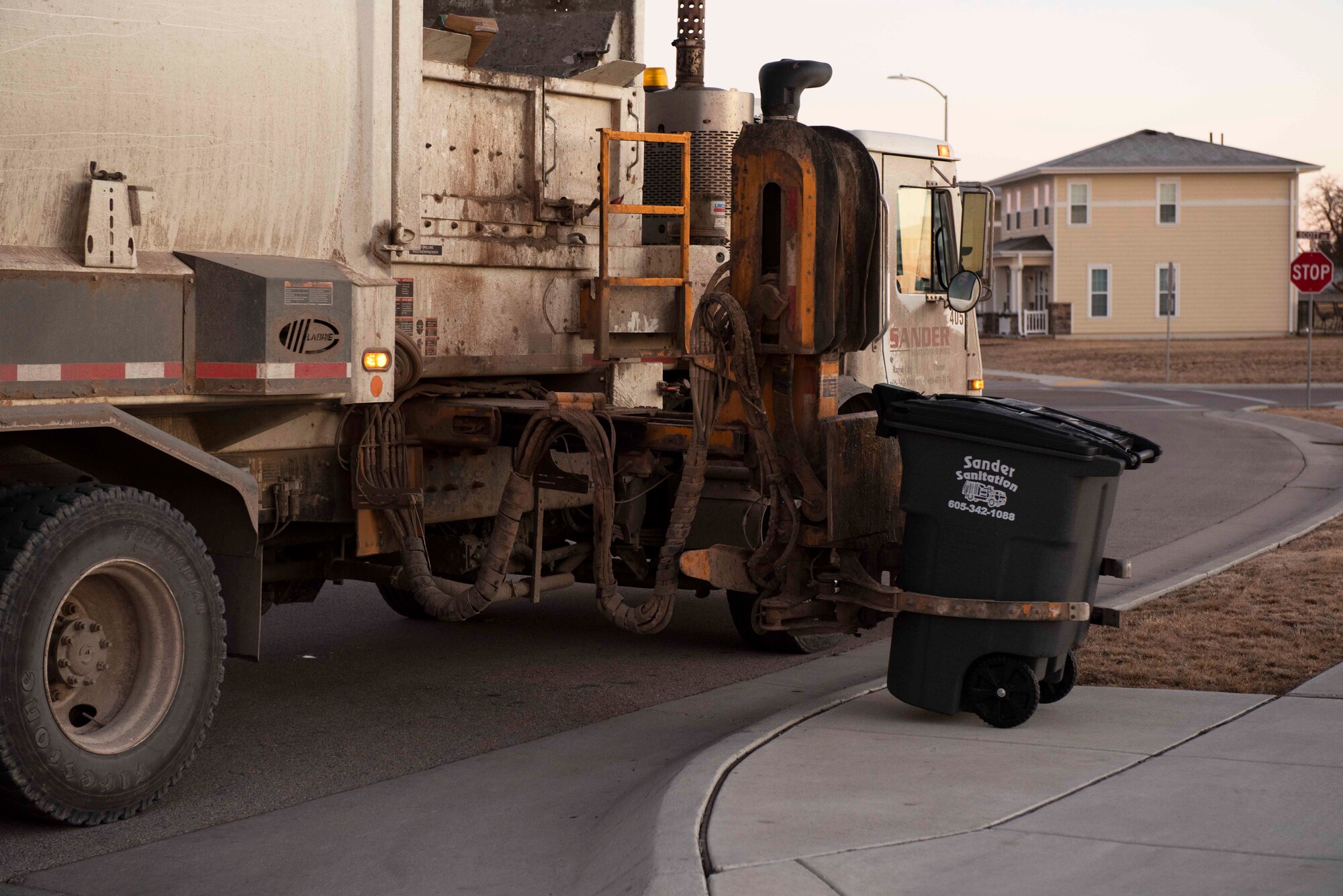 A trash can is lowered after being emptied at Ellsworth Air Force Base, S.D., Jan. 7, 2021.