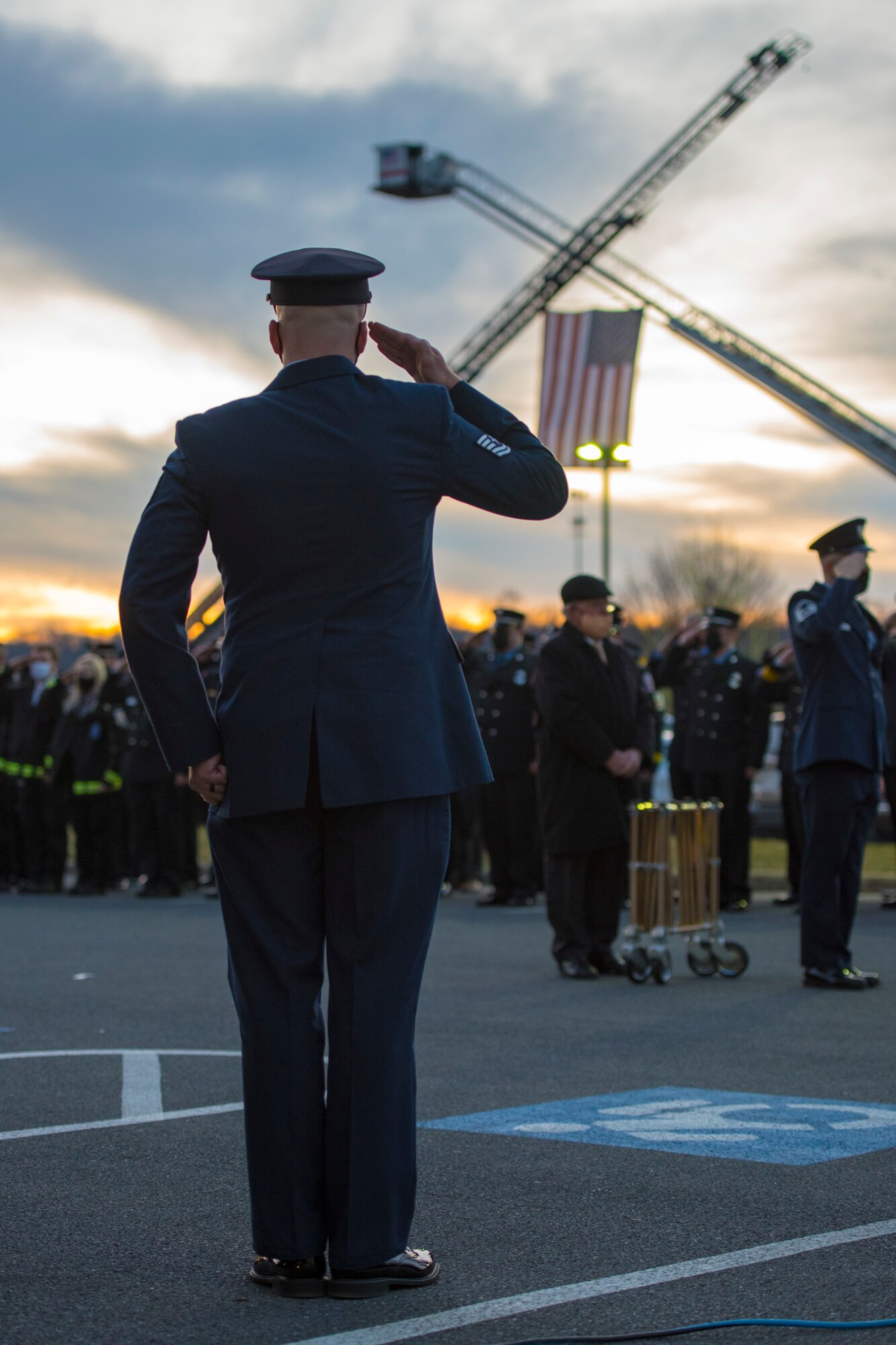 An Airman renders a salute at the conclusion of funeral services for Senior Airman Logan Young, a firefighter for the 167th Airlift Wing, at Victory Church, Winchester, Va., Jan. 7, 2021. Young died while battling an off-base barn fire Dec. 27, 2020.