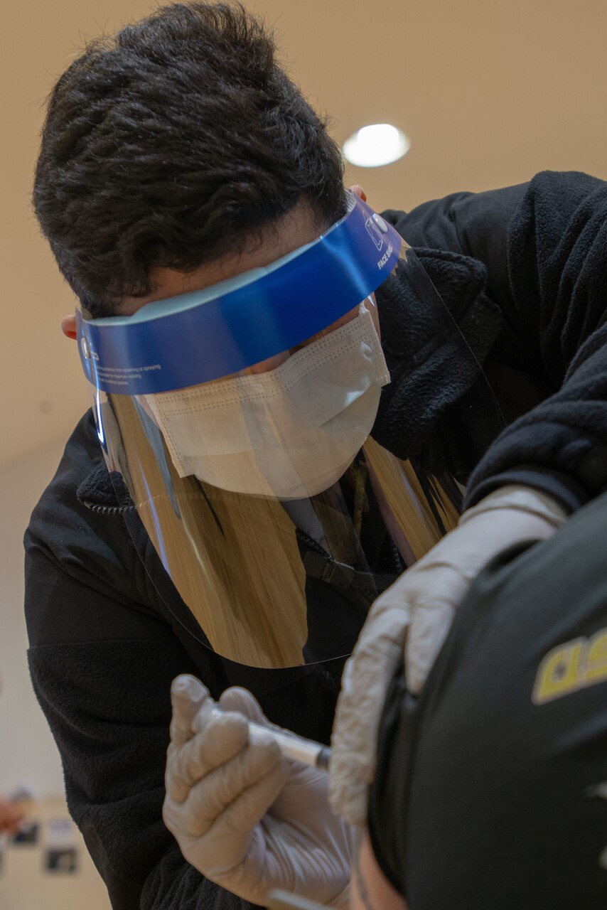 210108-N-LI114-1047 

YOKOSUKA, Japan (Jan. 8, 2021) Hospital Corpsman 2nd Class Anthony Turcios, assigned to the U.S. Navy’s only forward-deployed aircraft carrier USS Ronald Reagan (CVN 76), administers the COVID-19 vaccine to a patient on Commander, Fleet Activities Yokosuka (CFAY). Medical personnel and strategic forces were the first to receive the COVID-19 vaccine. Ronald Reagan returned to Yokosuka in November 2020 following a six-month deployment in the U.S. 7th Fleet area of responsibility. (U.S. Navy photo by Mass Communications Specialist 3rd Class Michael B. Jarmiolowski)