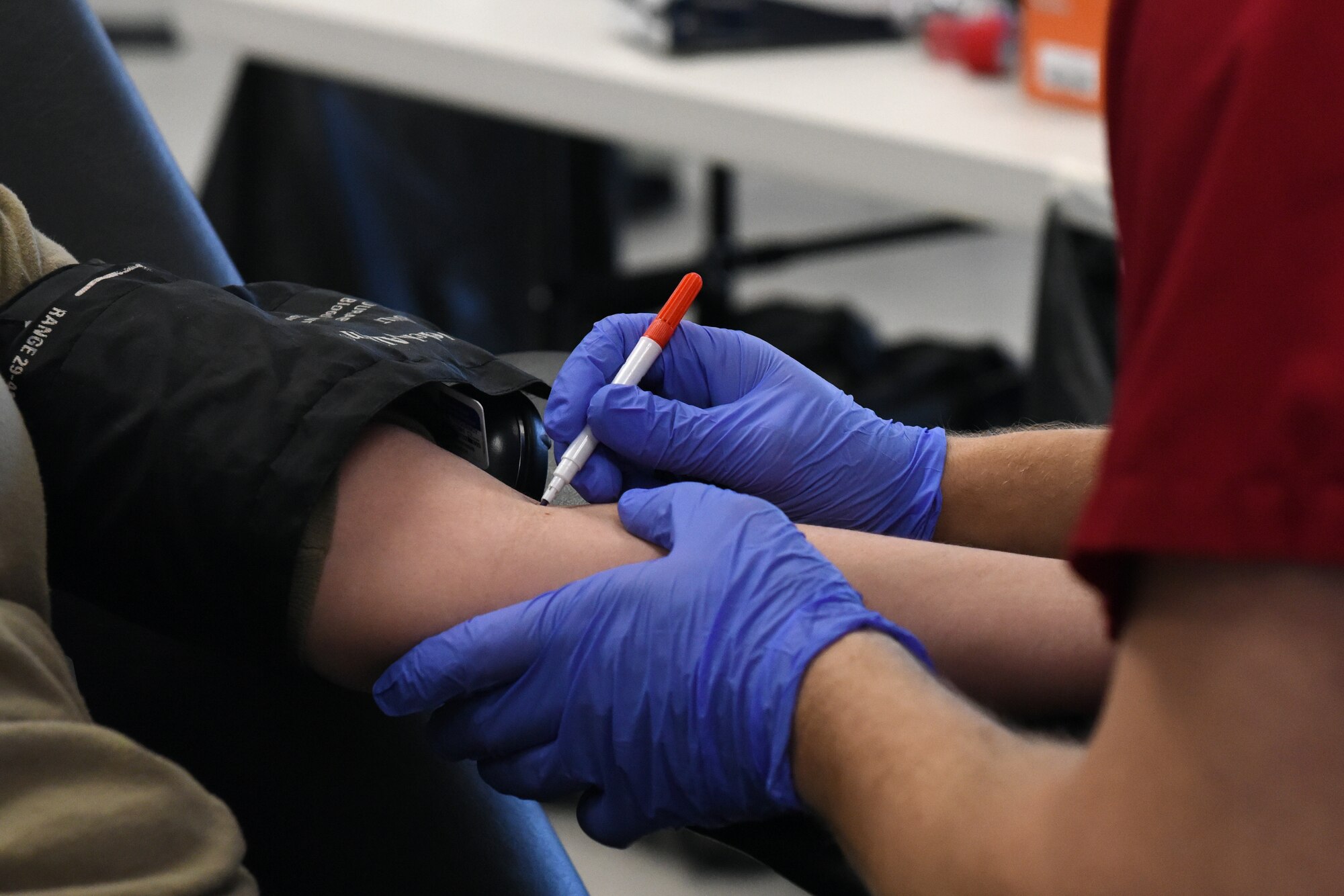 A Red Cross phlebotomist marks the vein on a 419th Fighter Wing reservist’s arm during the wing’s Bloody Warrior Drive Jan. 9, 2021, at Hill Air Force Base, Utah.