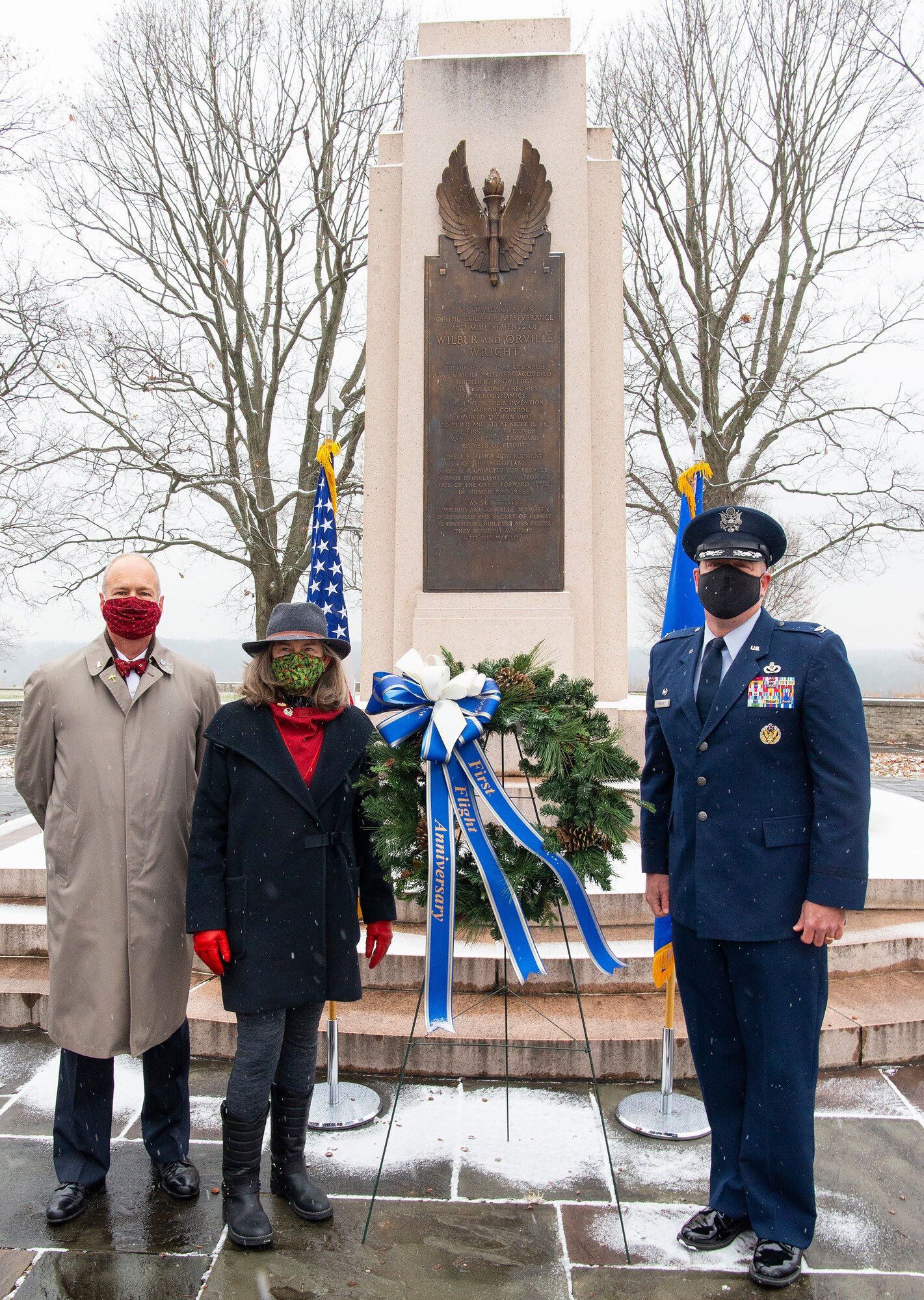Amanda Wright Lane and Stephen Wright, great-grandniece and great-grandnephew of the Wright brothers, and Col. Patrick Miller, 88th Air Base Wing and installation commander, lay a wreath at the Wright Brothers Memorial Dec. 17, 2020, during the annual anniversary of the first flight ceremony held on Wright-Patterson Air Force Base, Ohio. The memorial overlooks Huffman Prairie where the Wright brothers taught themselves and others how to fly. (U.S. Air Force photo by R.J. Oriez)