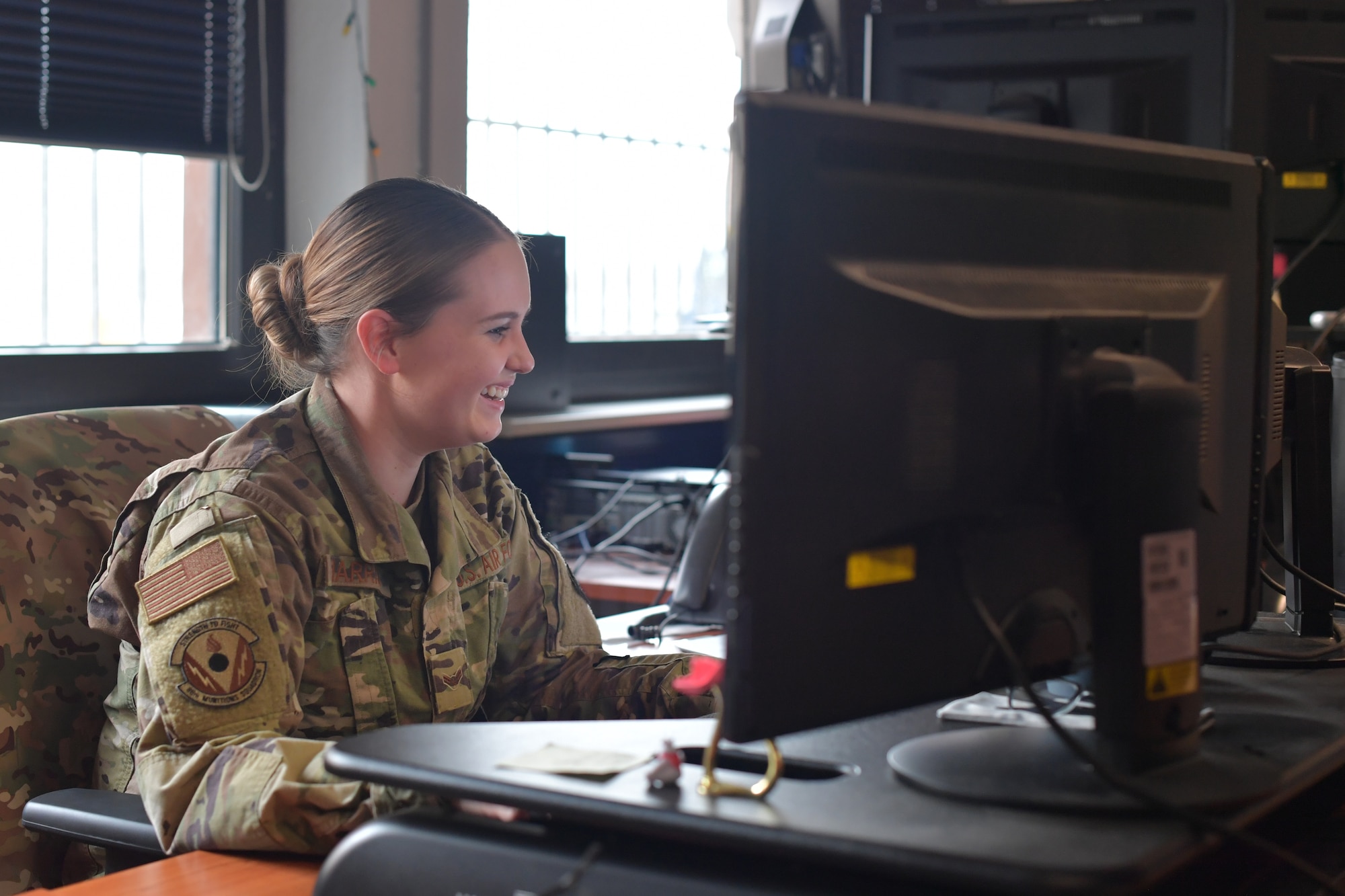 Airman sitting at a computer.