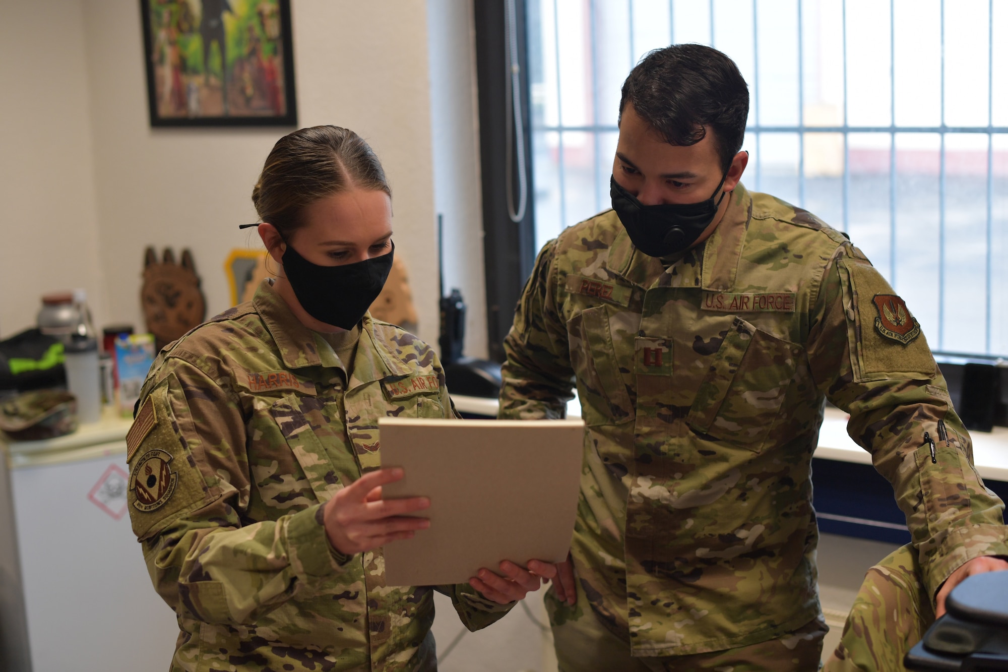 Two Airmen looking at a document.