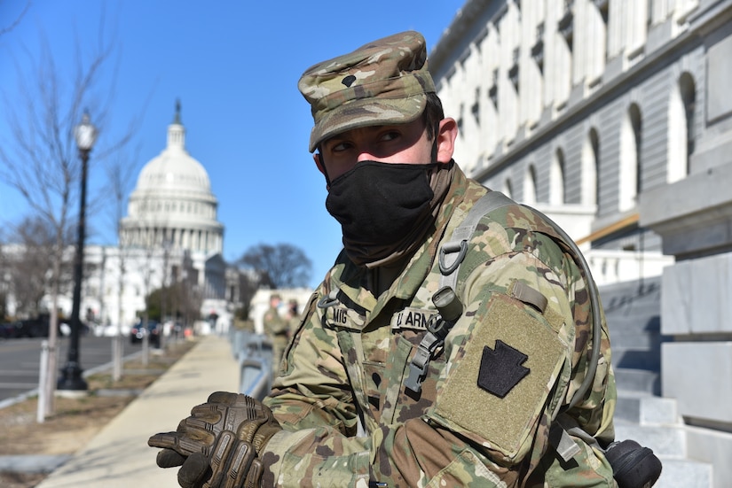 Spc. Kevin Romig,  2nd Squadron, 104th Cavalry Regiment, 56th Stryker Brigade Combat Team, Pennsylvania National Guard, from Reading, Pa., helps maintain a security perimeter around the U.S. Capitol in Washington, D.C., on Jan. 10, 2021. National Guard Soldiers and Airmen from several states have traveled to Washington to provide support to federal and district authorities leading up to the event.  (U.S. Air National Guard Photo by Master Sgt. George Roach)