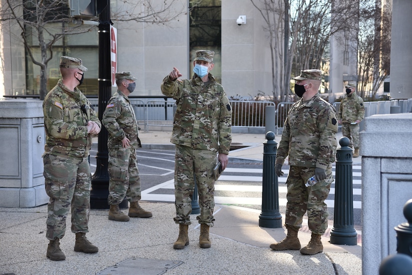 Col. Jon Farr, 56th Stryker Brigade Combat Team commander, inspects socially distanced security perimeters with Lt. Col. Adams, 2nd Squadron, 104th Cavalry Regiment, Pennsylvania Army National Guard in Washington, D.C., on Jan. 10, 2021.