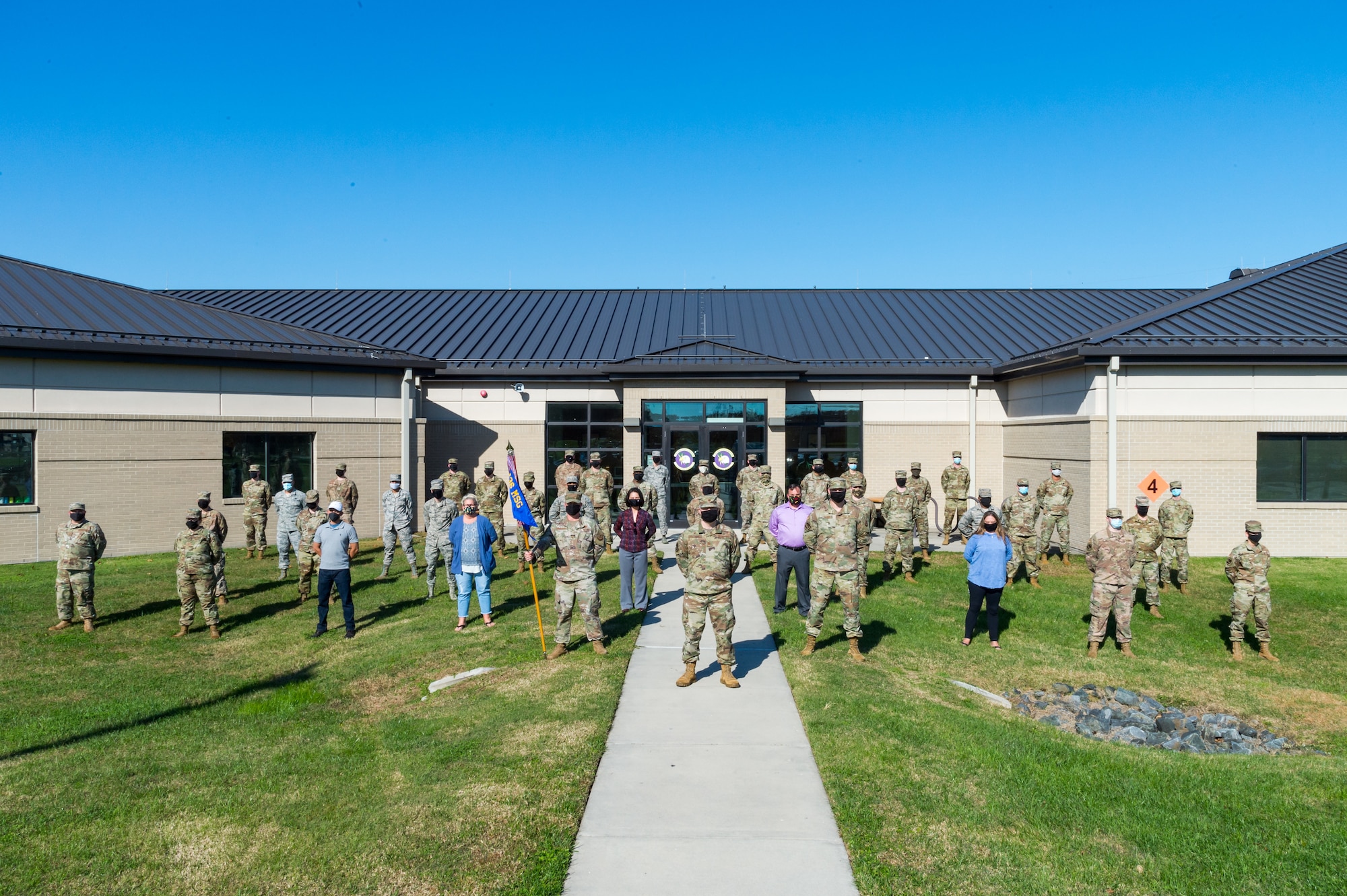 Personnel assigned to the 436th Communications Squadron stand in front of their building for a photo Nov. 9, 2020, at Dover Air Force Base, Delaware. Standing in the center is Maj. Peter Dell'Accio, 436th CS commander; to his left is Senior Master Sgt. Adam Jensen, 436th CS superintendent; and to his right is Master Sgt. Christopher Anderson, 436th CS first sergeant. The 436th CS plans, installs, operates and maintains $75 million in command, control, communications, computer and visual information systems for two C-5 airlift wings and the National Weather Service. Mission areas include classified and unclassified data networks, airfield navigation and landing equipment, air traffic control systems maintenance, airport surveillance and weather radar, telephone and wireless communications, public address systems, frequency management and base information management. (U.S. Air Force photo by Airman Cydney Lee)