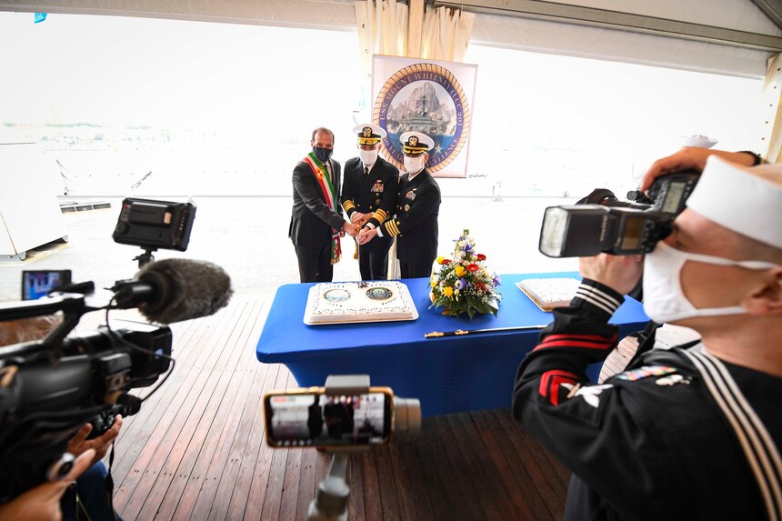 120114-N-XT273-0369 GAETA, Italy (Jan. 14, 2021) Cosmo Mitrano, Mayor of Gaeta, left, Vice Adm. Gene Black, Commander, U.S. Sixth Fleet, center, and Capt. Dave Pollard, USS Mount Whitney commanding officer, cut cake aboard the U.S. Sixth Fleet command and control ship USS Mount Whitney (LCC 20) during the ship’s 50th anniversary celebration, Jan. 14, 2021, in Gaeta, Italy. U.S. Sixth Fleet, headquartered in Naples, Italy, conducts the full spectrum of joint and naval operations, often in concert with allied and interagency partners, in order to advance U.S. national interests, security and stability in Europe and Africa. (U.S. Navy photo by Chief Mass Communication Specialist Justin Stumberg/ Released)