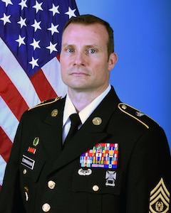 US Army Official Photo CSM Patrick "Gene" Cunningham - with flag.