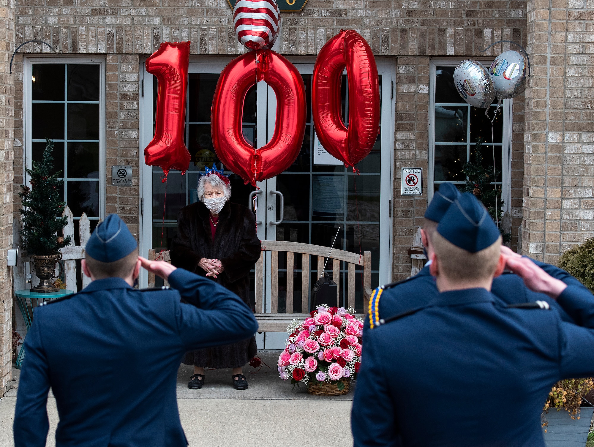 Air Force ROTC cadets salute Tipi Minnehan Dec. 23, 2020, on her 100th birthday in Fairborn, Ohio. Minnehan is a veteran having served in the Army during, and for a few years after, World War II. (U.S. Air Force photo by R.J. Oriez)