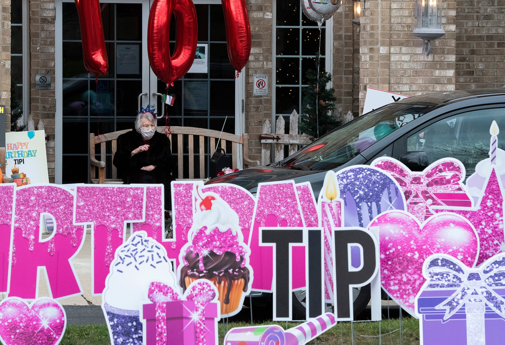 Tipi Minnehan greets family and friends during a birthday parade held in honor of her 100th birthday Dec. 23, 2020. Friends and family, in a long line of cars, drove past the World War II Army veteran’s residence in Fairborn, Ohio, to safely wish her well. (U.S. Air Force photo by R.J. Oriez)