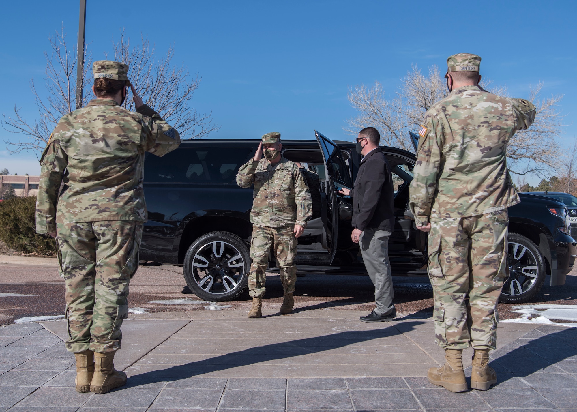 Two Delta 2 personnel salute Gen. James H. Dickinson as he exits his vehicle.