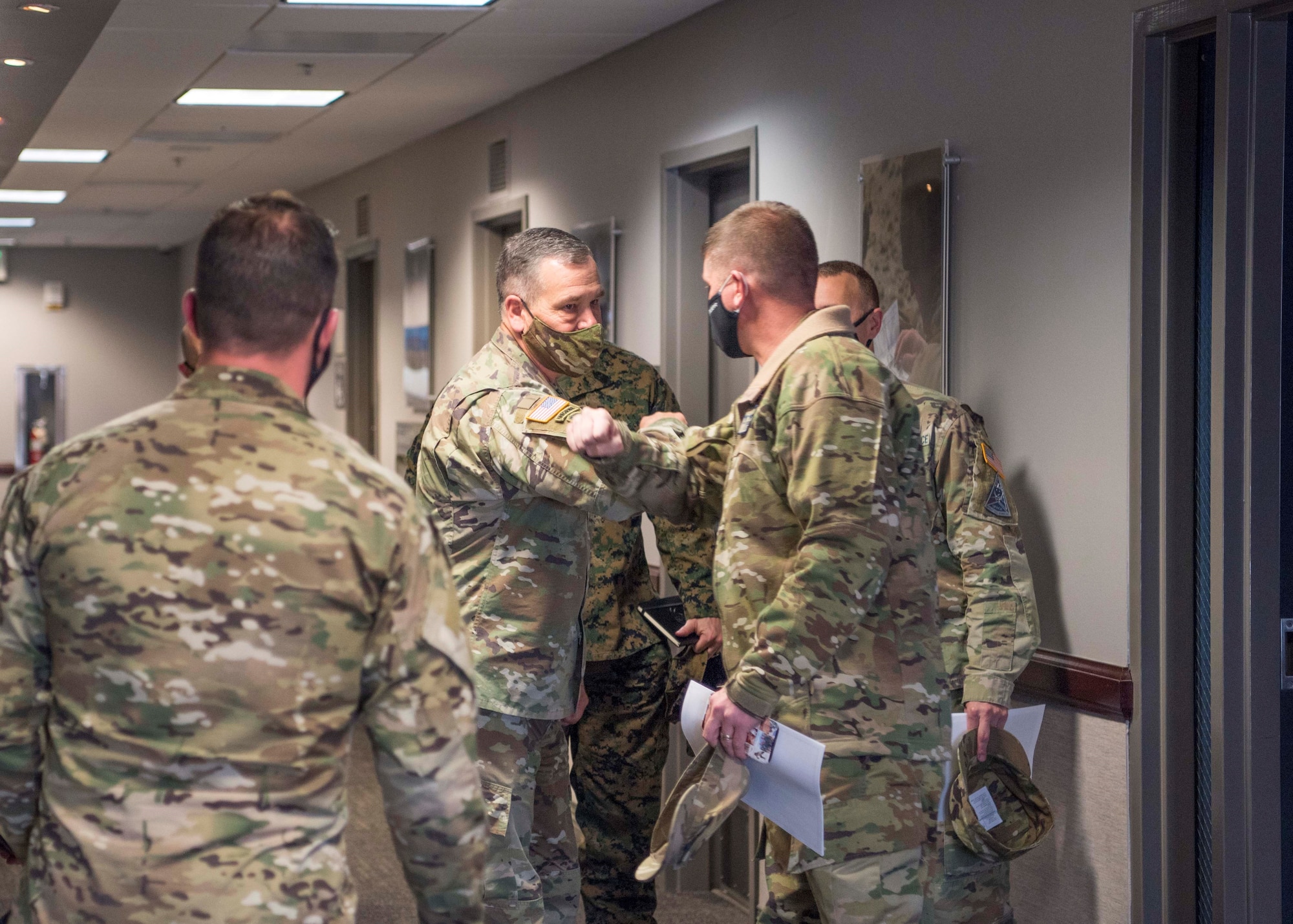 U.S. Army Gen. James H. Dickinson bumps elbows with a member of Delta 3 leadership