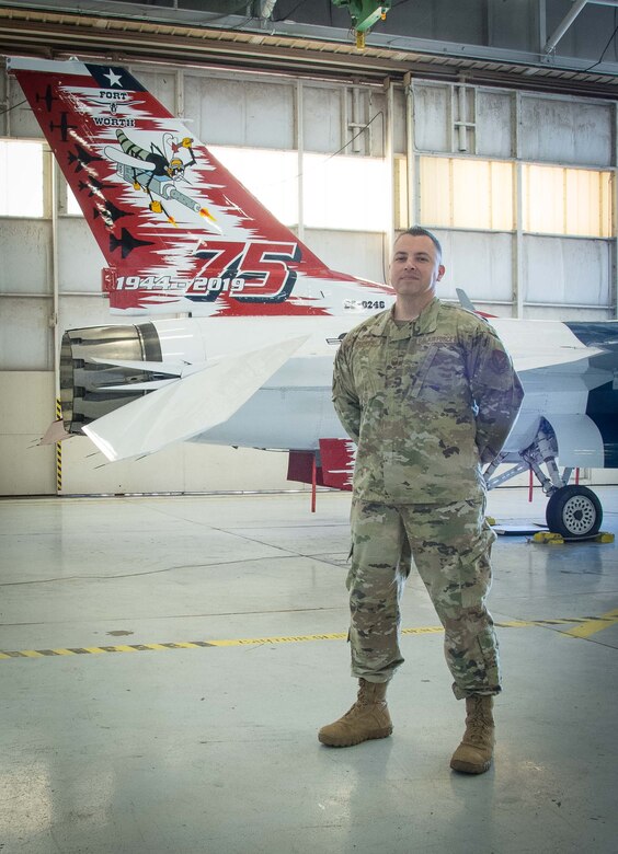 Master Sgt. David Flores, 301st  Fighter Wing Operations Group first sergeant, stands by the 301 FW F-16 heritage jet at U.S. Naval Air Station Joint Reserve Base Fort Worth, Texas on December 20, 2020. First Sgts. play a vital role to a wing's ability to accomplish their mission because they work directly with the Airmen in their respective squadrons. (U.S. Air Force photo by Jeremy Roman)