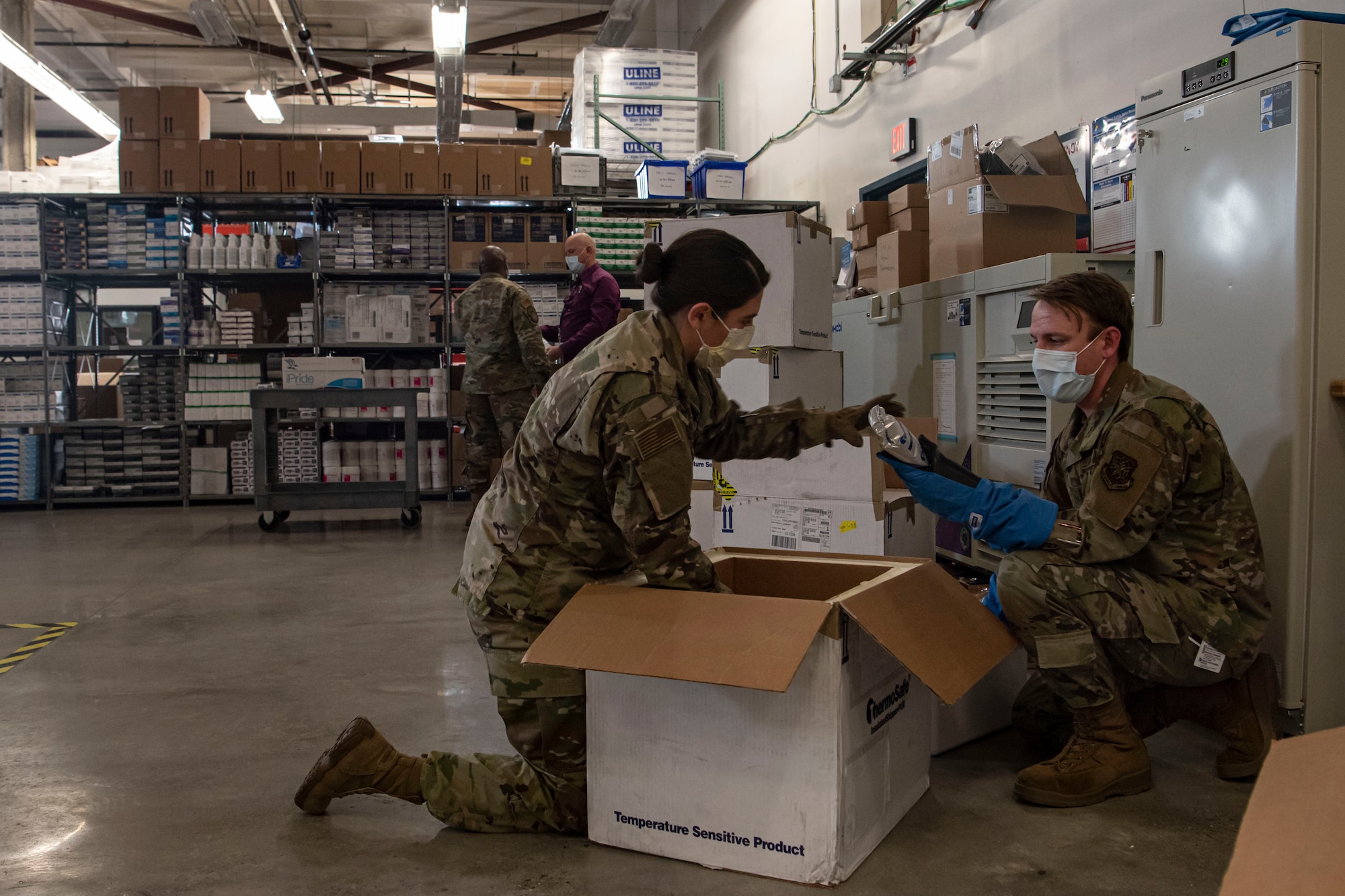 Photo of Airmen packing a COVID-19 vaccine shipment.