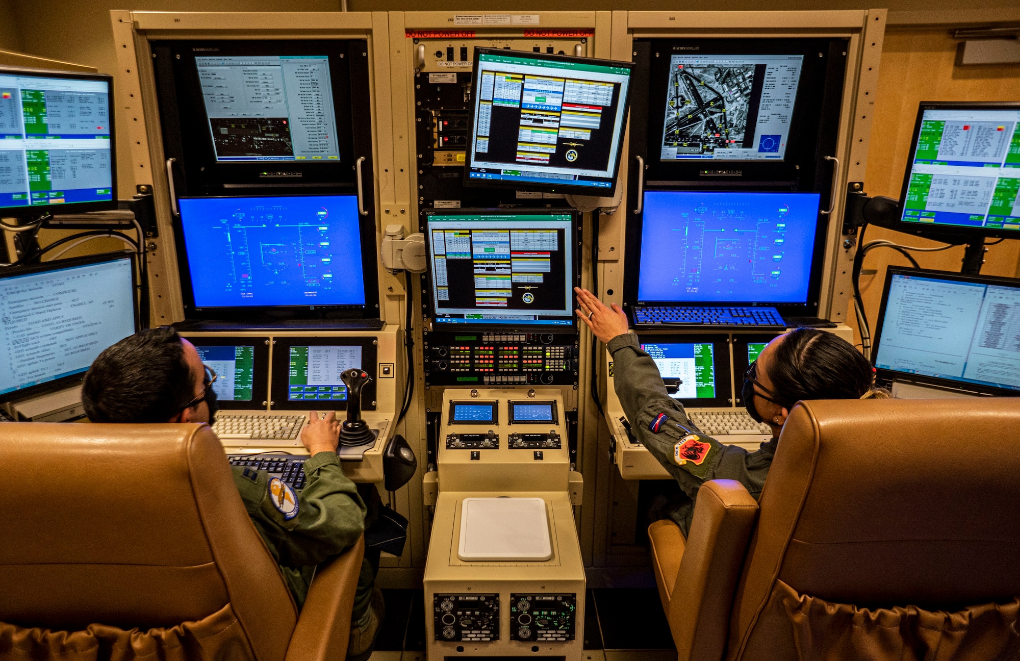 489th Attack Squadron aircrew sit in a simulator.