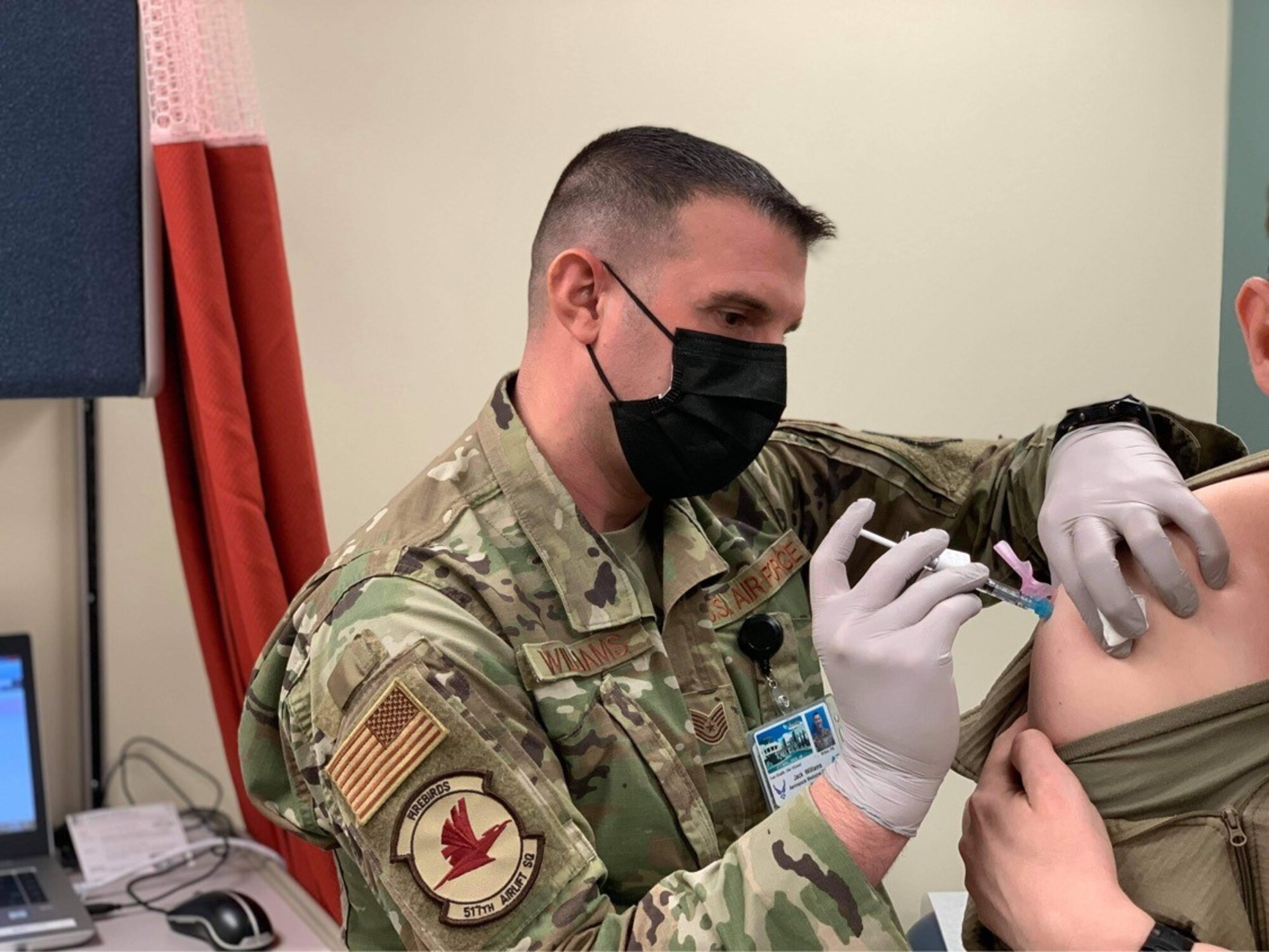Air Force Tech. Sgt. Jack Williams, 517th Airlift Squadron independent duty medical technician, administers the COVID-19 vaccine, Dec. 30, 2020 at Joint Base Elmendorf-Richardson, Alaska. IDMTs role is to communicate issues affecting the combat readiness, mission effectiveness, and individual medical readiness directly to the commander while advising them on recommendations to perform safe, effective flying operations.