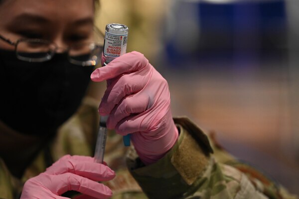 Tech. Sgt. Alexandra Golas, 45th Operational Medical Readiness Squadron flight chief, prepares a COVID-19 vaccine at Patrick Space Force Base, Fla., Jan. 14, 2021. The 45th Medical Group administered the first round of the vaccine in accordance with the Department of Defense's COVID-19 vaccine distribution plan. (U.S. Space Force Photo By Airman First Class Thomas Sjoberg)