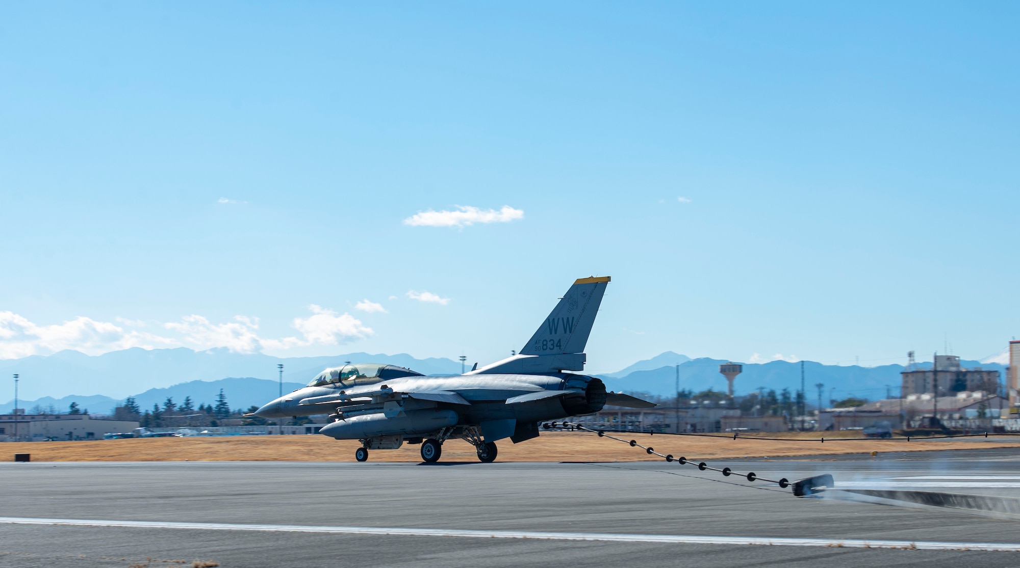 An F-16DJ Fighting Falcon assigned to Misawa Air Base, Japan, catches a barrier cable during the initial certification test of the newly installed flightline BAK-12 barrier, aircraft arresting system (AAS)