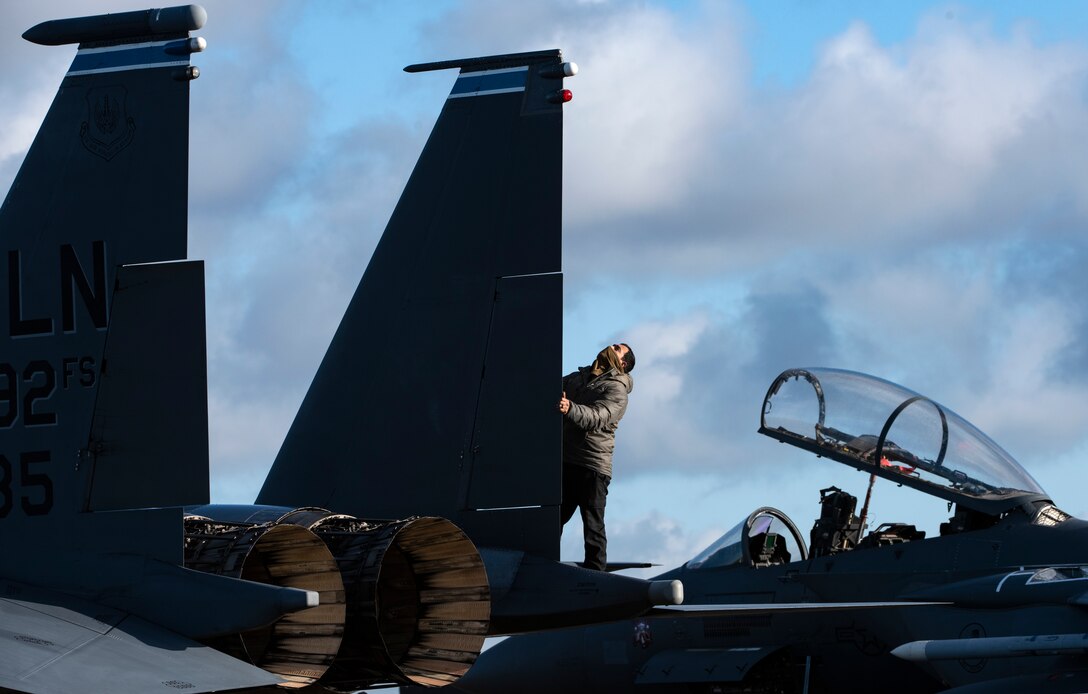 U.S. Air Force Staff Sgt. Miguel Talamantes, 492nd Aircraft Maintenance Unit crew chief, performs routine pre-flight checks on an F-15E Strike Eagle during Agile Combat Employment training at Royal Air Force Lakenheath, England, Jan. 12, 2021.  Exercising elements of ACE enables U.S. Air Forces in Europe to operate from locations with varying levels of capacity and support, ensuring Airmen and aircrews are postured to deliver lethal combat power across the spectrum of military operations. (U.S. Air Force photo by Airman 1st Class Jessi Monte)