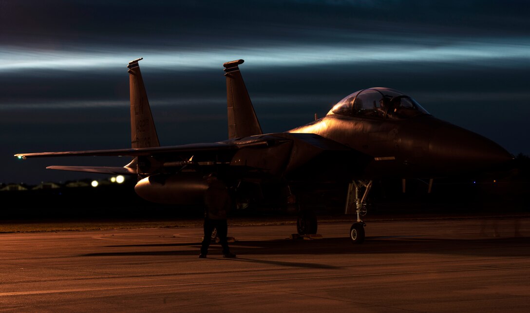 A U.S. Air Force Airman from the 48th Aircraft Maintenance Squadron performs pre-flight checks on an F-15E Strike Eagle during Agile Combat Employment training at Royal Air Force Lakenheath, England, Jan. 12, 2021. Agile Combat Employment capabilities ensure U.S. Air Forces in Europe, along with allies and partners, are ready for potential last minute contingencies by allowing forces to operate from locations with varying levels of capacity and support. (U.S. Air Force photo by Airman 1st Class Jessi Monte)