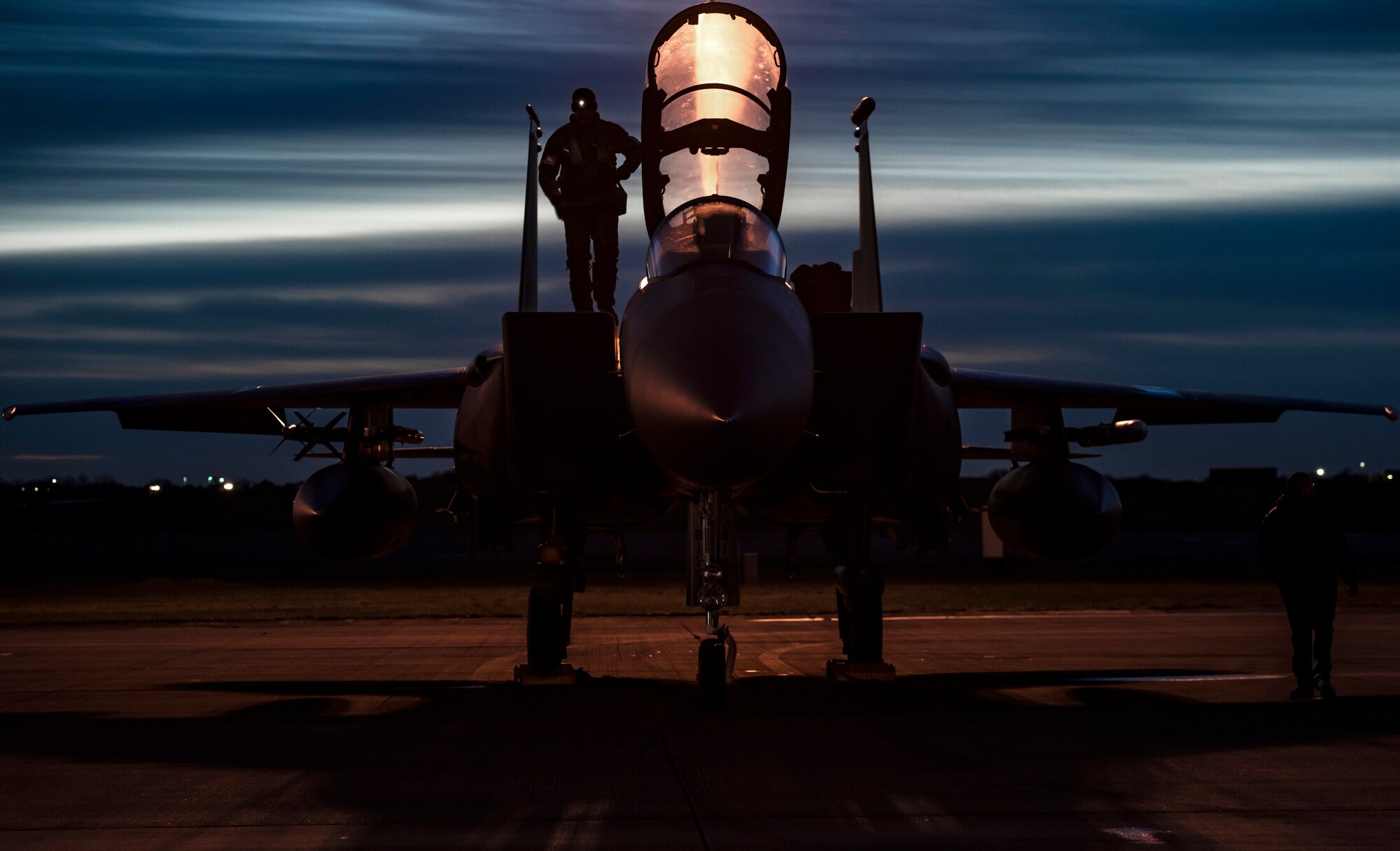 A U.S. Air Force aircrew member assigned to the 492nd Fighter Squadron prepares to enter the cockpit of an F-15E Strike Eagle prior to evening take-offs during Agile Combat Employment training at Royal Air Force Lakenheath, England, Jan. 12, 2021. Training incorporating ACE concepts contribute to the development of multi-capable Airmen and aircrew, improving interoperability and helping allies and partners increase their capabilities in less than optimal environments. (U.S. Air Force photo by Airman 1st Class Jessi Monte)