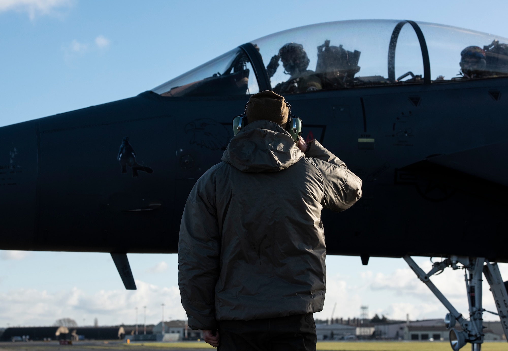 A U.S. Air Force Airman assigned to the 48th Aircraft Maintenance Squadron salutes aircrew as they taxi onto the flightline during Agile Combat Employment training at Royal Air Force Lakenheath, England, Jan. 12, 2021. Exercising elements of ACE enables U.S. Air Forces in Europe to operate from locations with varying levels of capacity and support, ensuring Airmen and aircrews are postured to deliver lethal combat power across the spectrum of military operations. (U.S. Air Force photo by Airman 1st Class Jessi Monte)