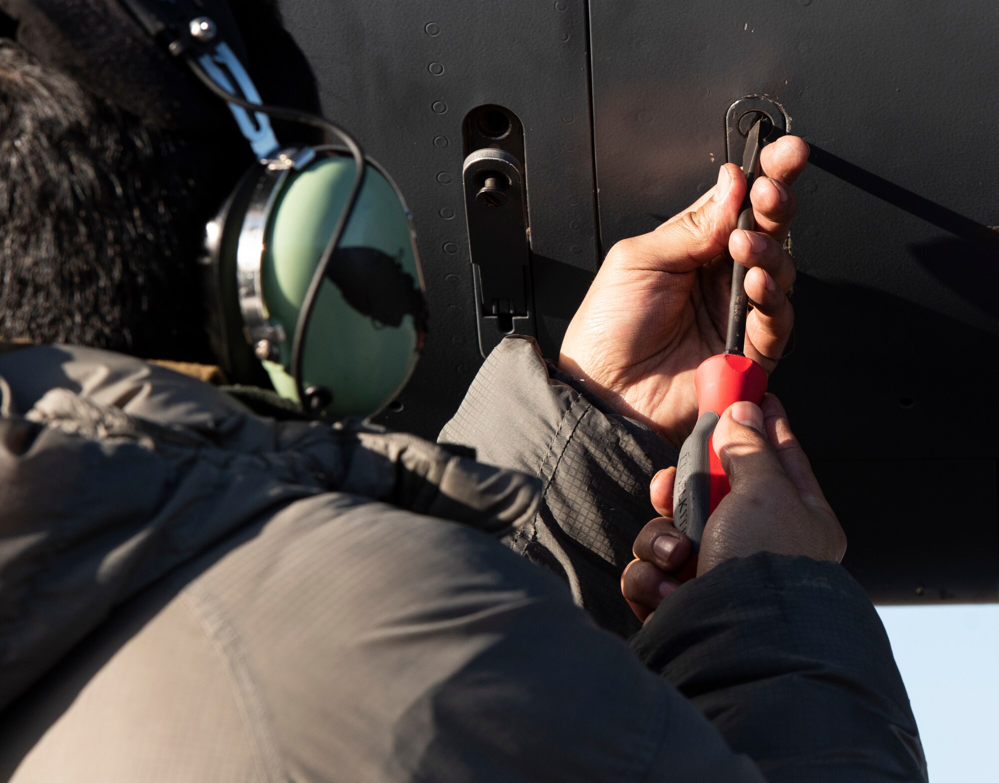 U.S. Air Force Staff Sgt. Miguel Talamantes, 492nd Aircraft Maintenance Unit crew chief, secures a panel on an F-15E Strike Eagle during Agile Combat Employment training at Royal Air Force Lakenheath, England, Jan. 12, 2021. Exercising elements of ACE enables U.S. Air Forces in Europe to operate from locations with varying levels of capacity and support, ensuring Airmen and aircrews are postured to deliver lethal combat power across the spectrum of military operations. (U.S. Air Force photo by Airman 1st Class Jessi Monte)