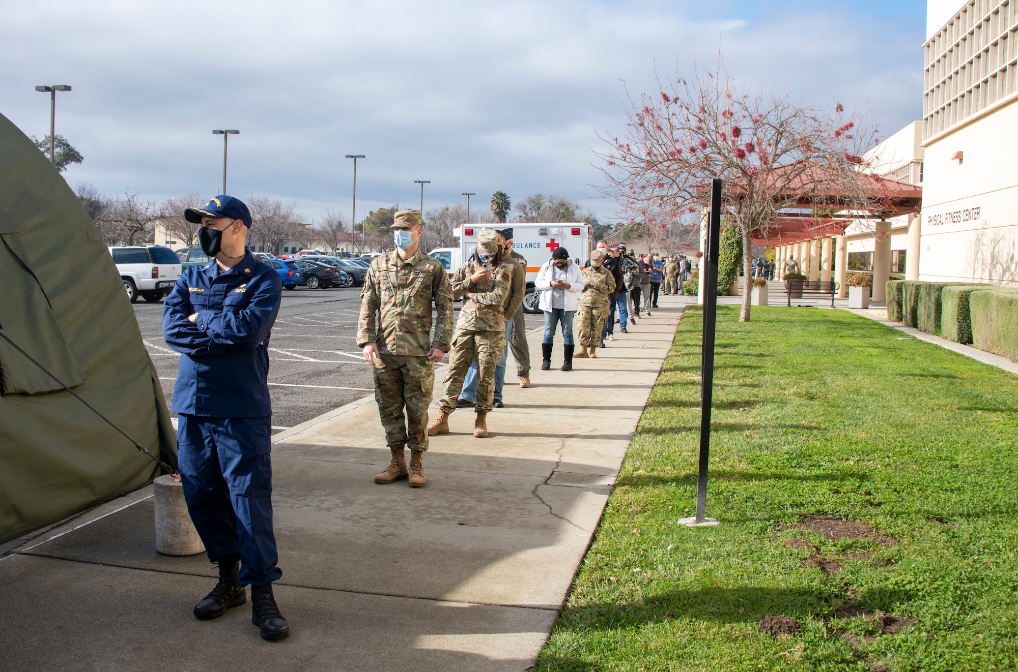 Department of Defense personnel line up to receive the initial dose of the COVID-19 vaccine at the Fitness Center, Travis Air Force Base, California, Jan. 8, 2021. The vaccine requires two doses per person, separated by about four weeks between doses. It is designed to protect personnel against the coronavirus, and officials are encouraging all prioritized personnel to take the vaccine as it becomes available. (U.S. Air Force photo by Heide Couch)