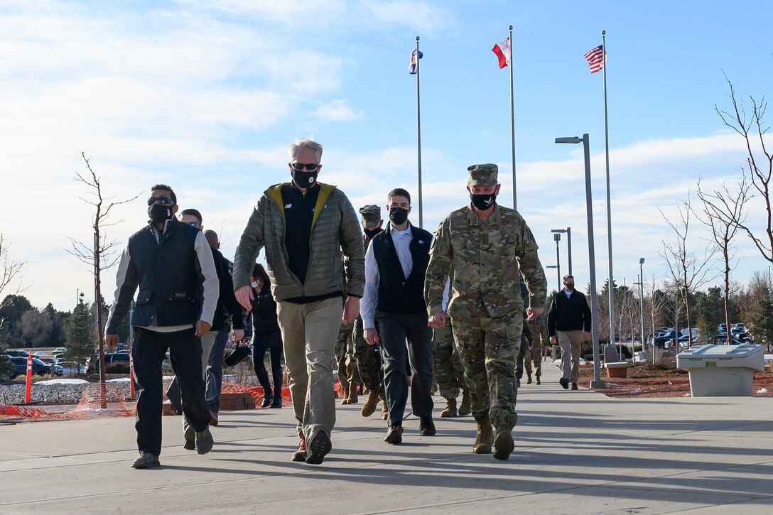 A group of people walk toward the camera.